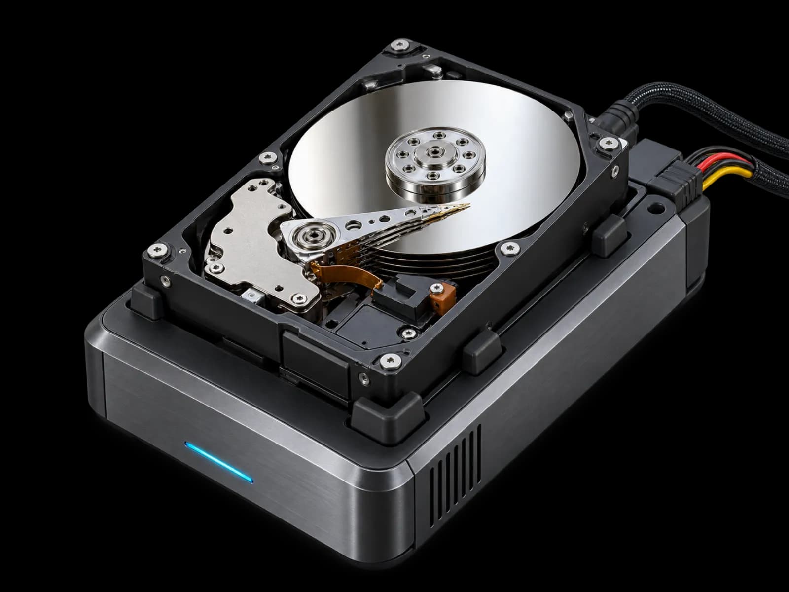 An opened hard drive connected to a professional forensic imaging dock