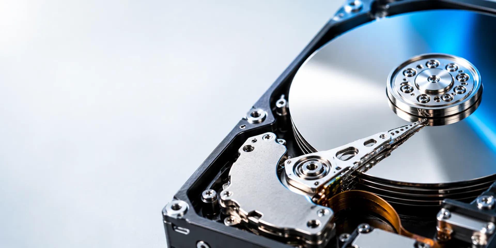 Macro view of an open hard-drive platter with clean negative space for the data recovery call to action