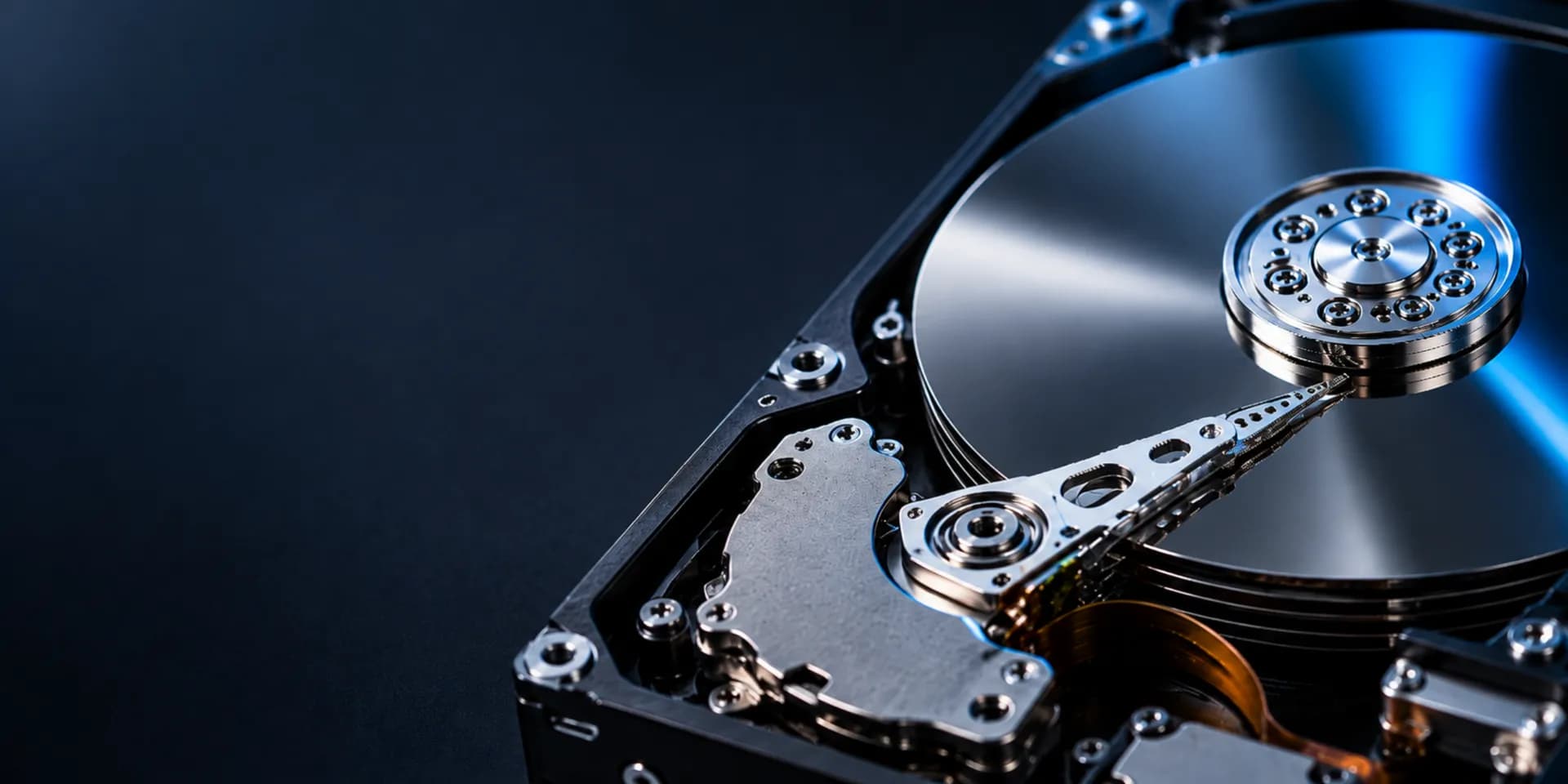 Macro view of an open hard-drive platter with clean negative space for the data recovery call to action